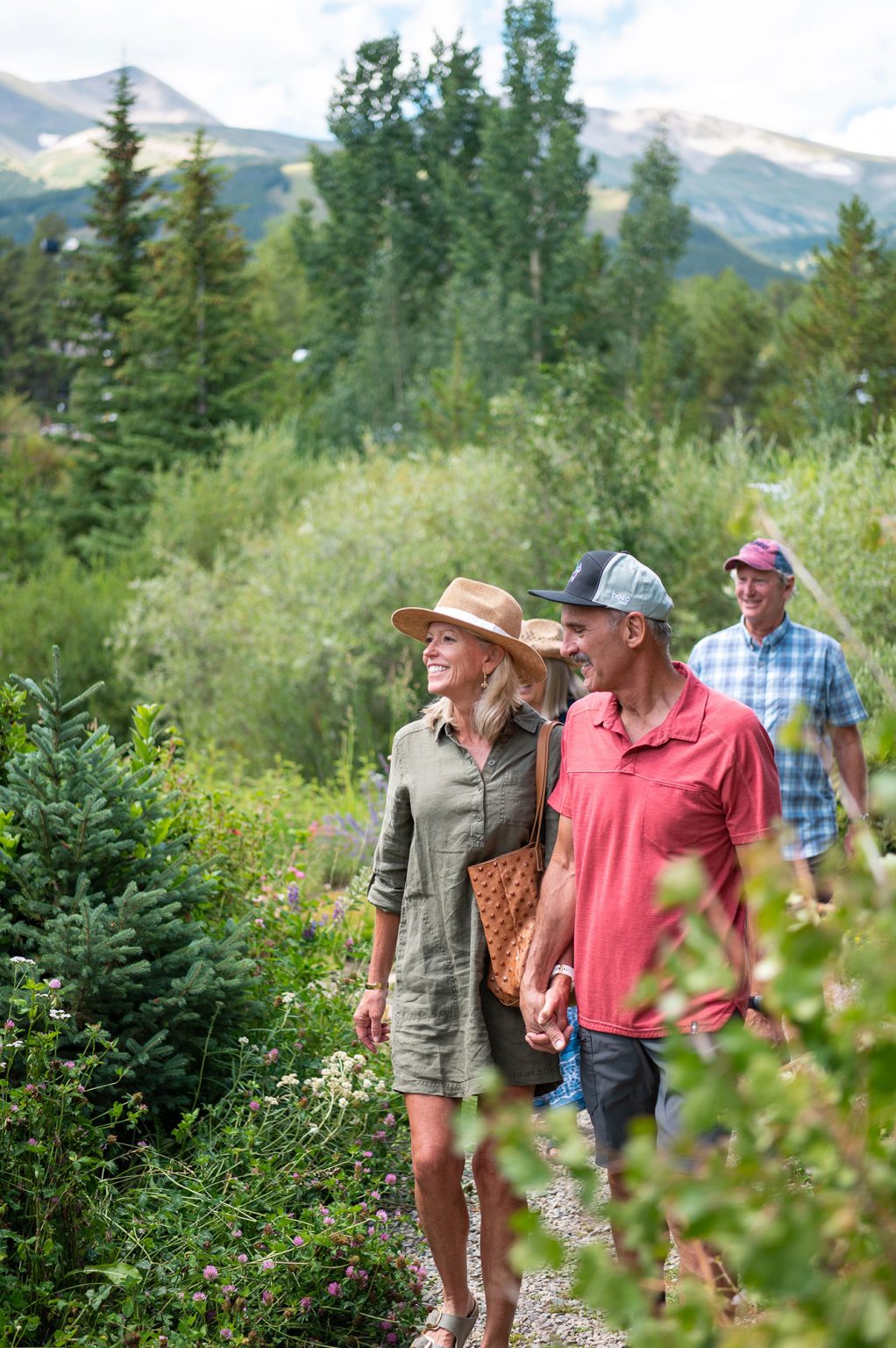 two couples walking through field