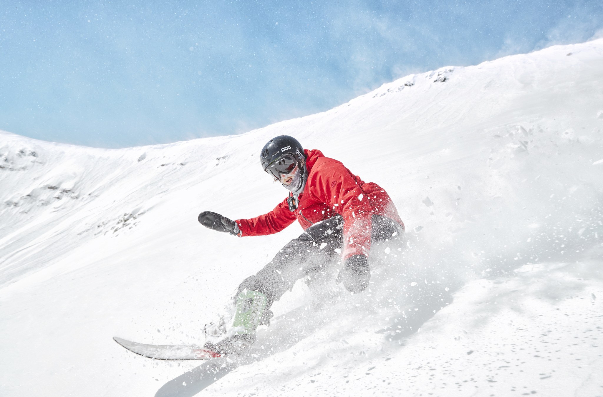 A snowboarding riding powder at Breckenridge Ski Resort. Take a snowboard lesson to improve your skills!