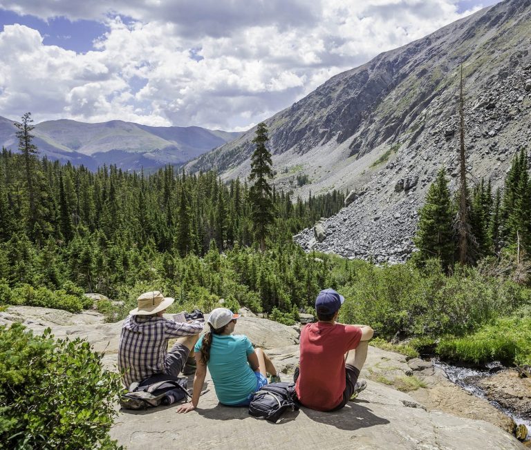 Hikers taking a break on a rock in Breckenridge