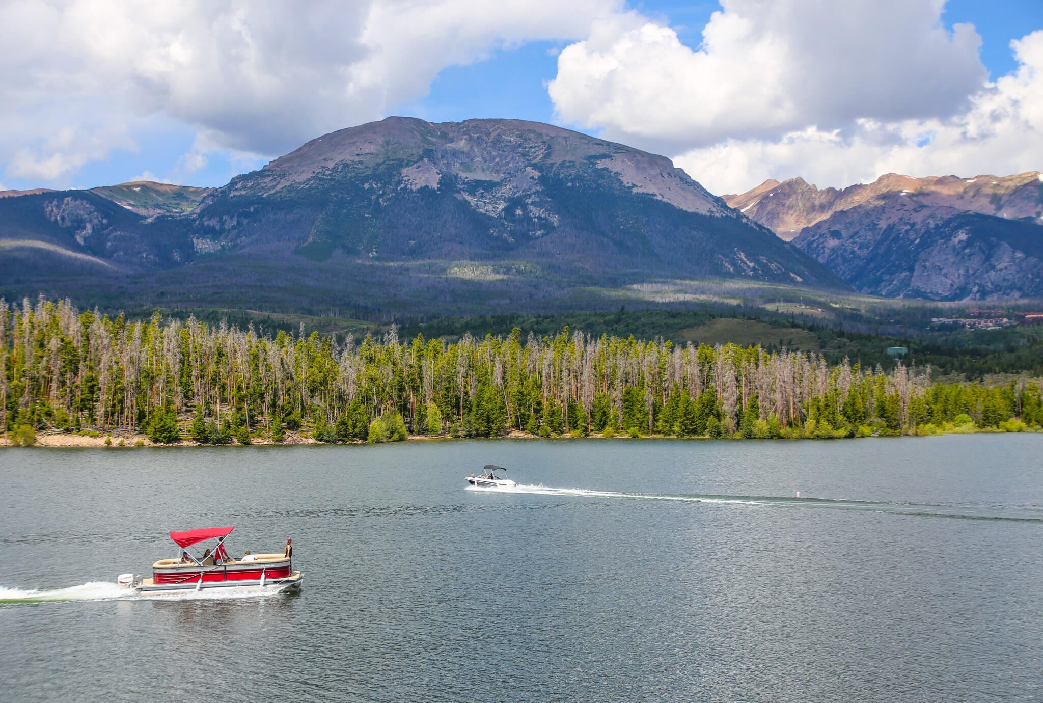 Pontoon boats on Lake Dillon in Breckenridge with views of the mountains.