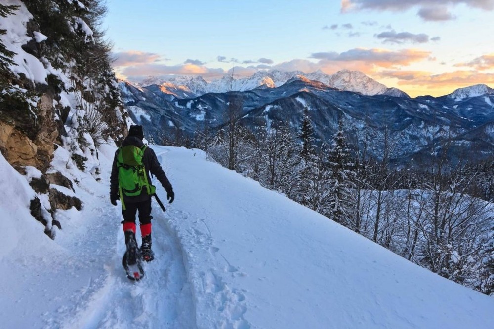 Person snowshoeing through the rocky mountains.