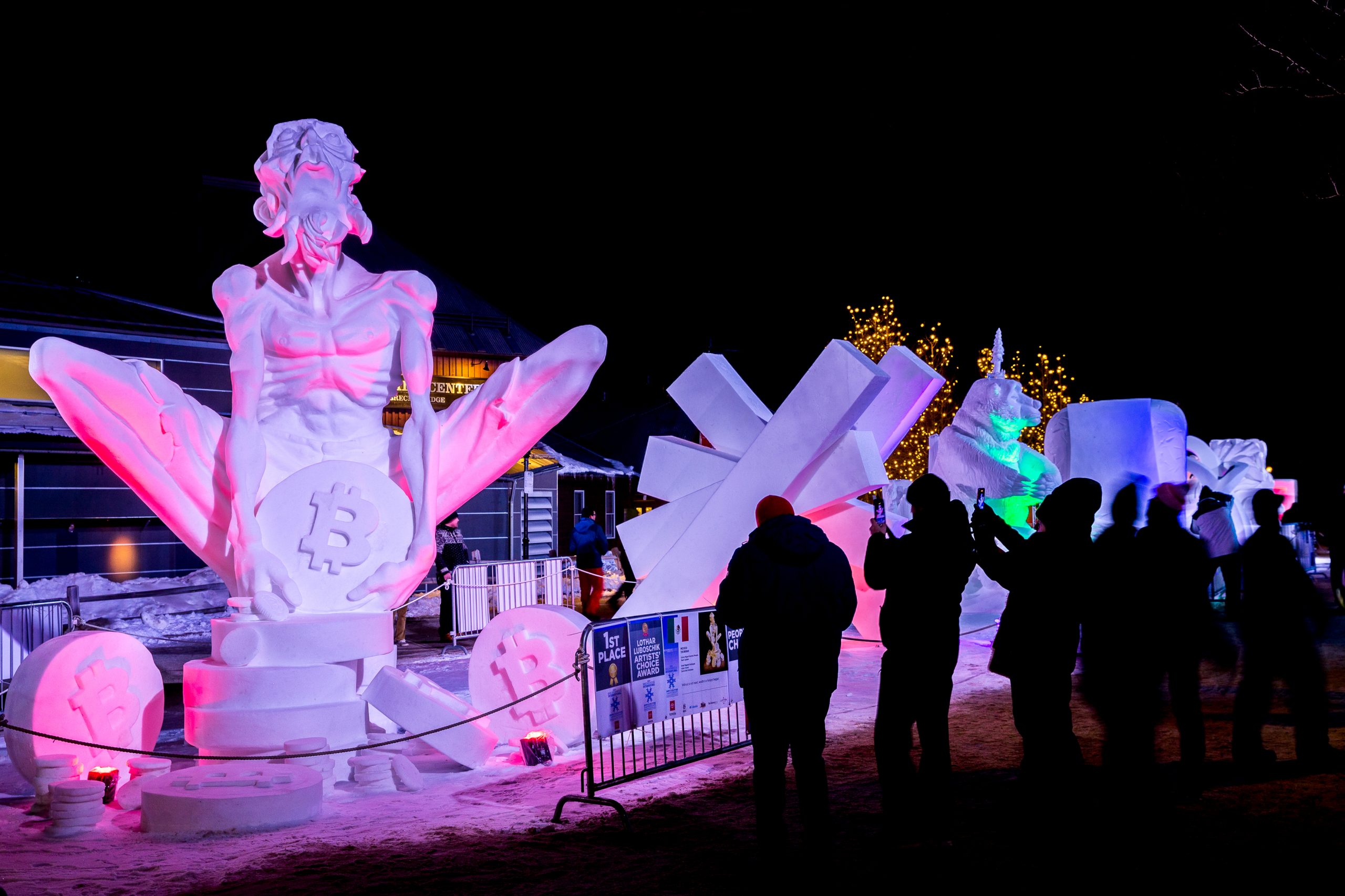 snow sculptures are lit up by colorful lights at night in Breckenridge