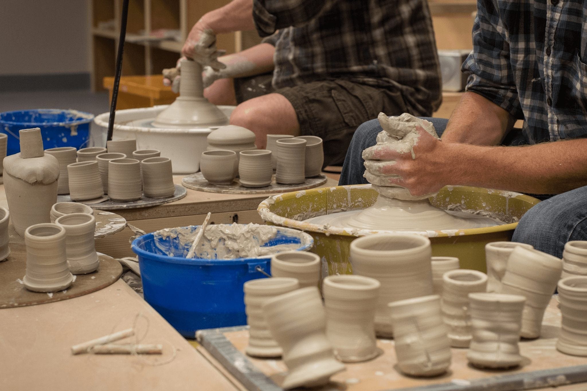 Hands making ceramics during a class in the Breckenridge Arts District.