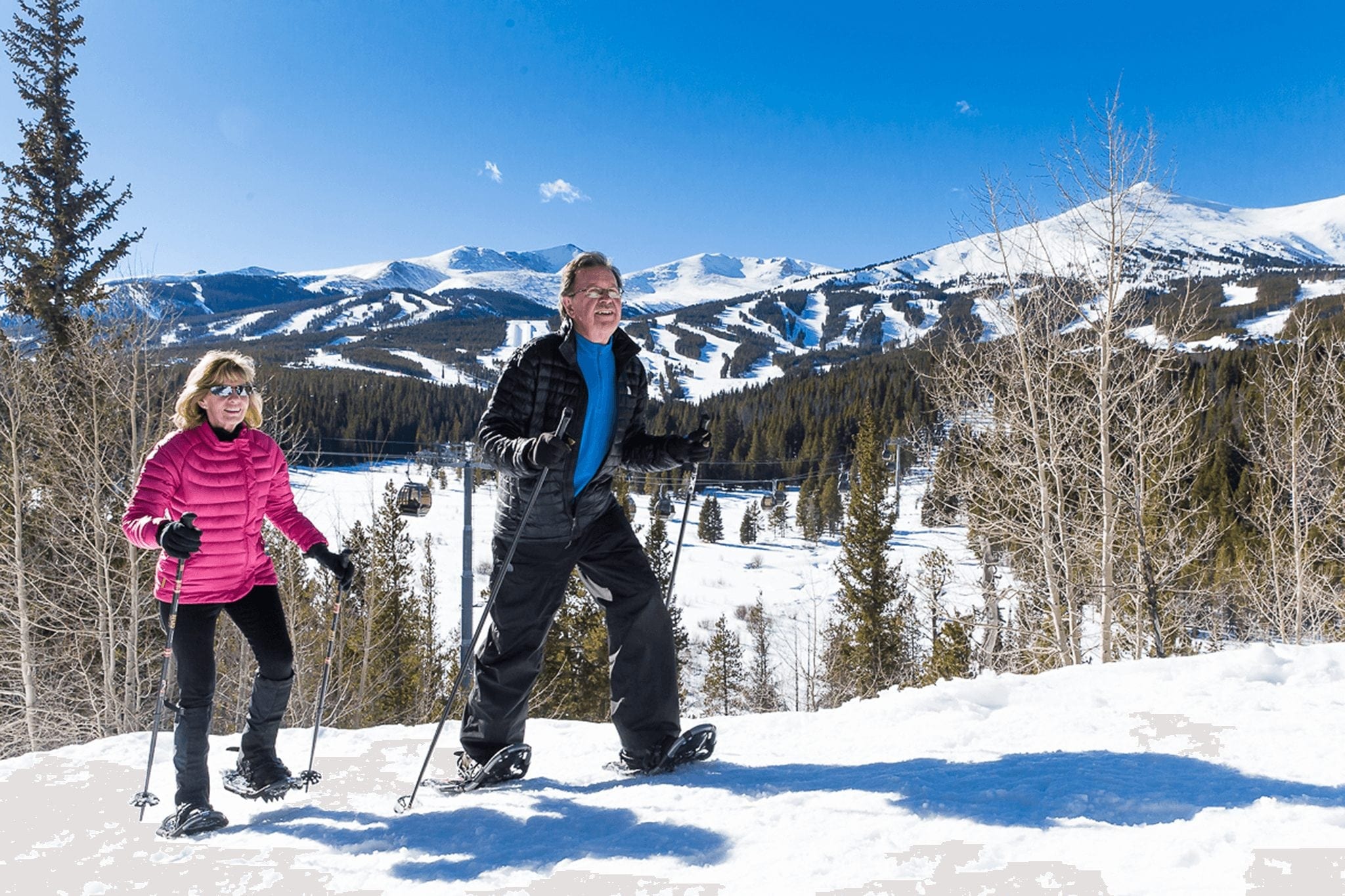A couple snowshoeing in Breckenridge. Snowshoeing is one of the most popular Breckenridge winter activities.