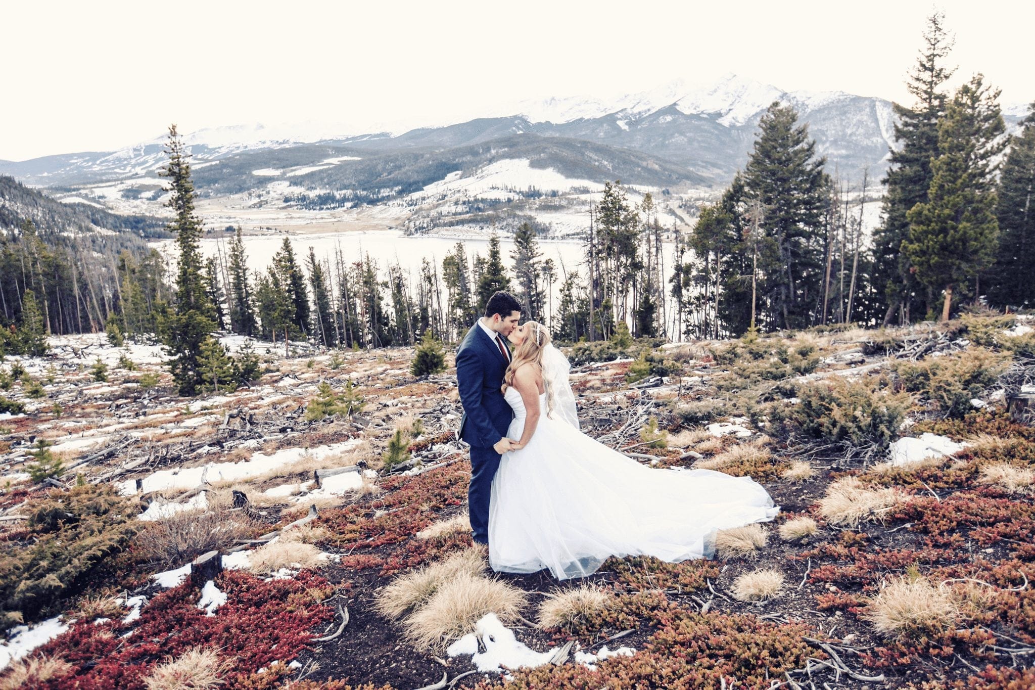 Bride and Groom kissing on the mountainside during their wedding in Breckenridge.