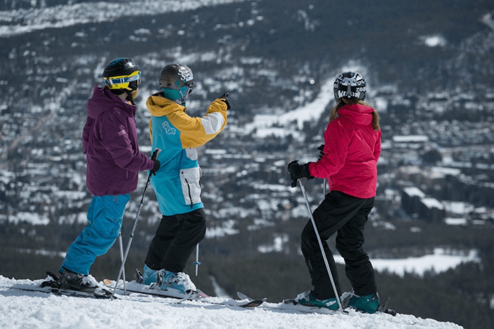 Group of skiers deciding which run to ski at the top Breckenridge ski run