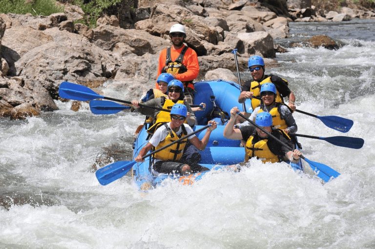 A group trip rafts in Breckenridge on a beautiful summer day
