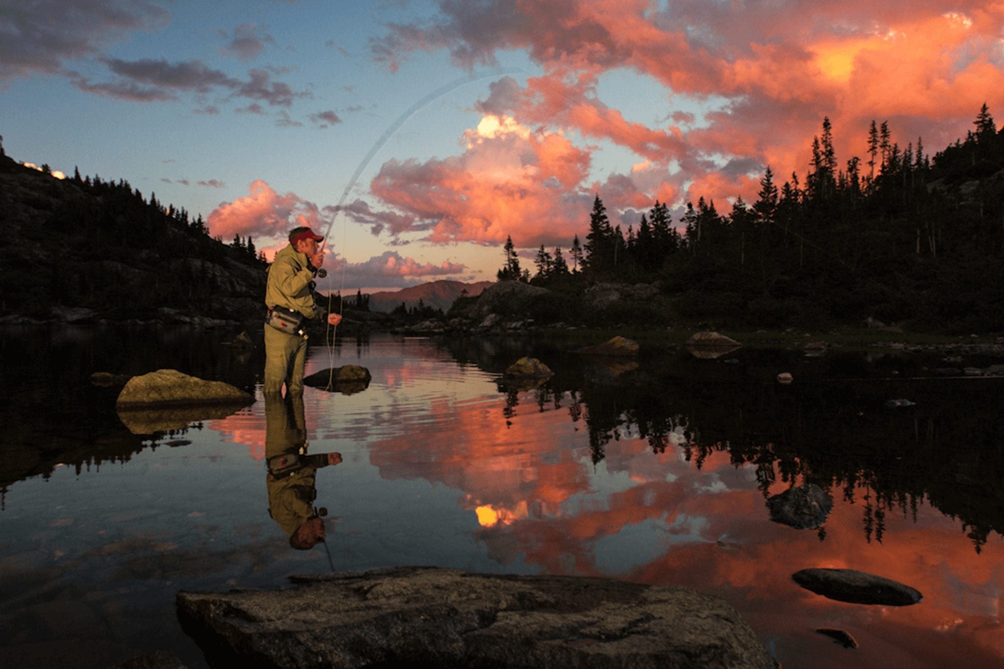 A man fly fishing during sunset at Mohawk Lakes in Breckenridge.