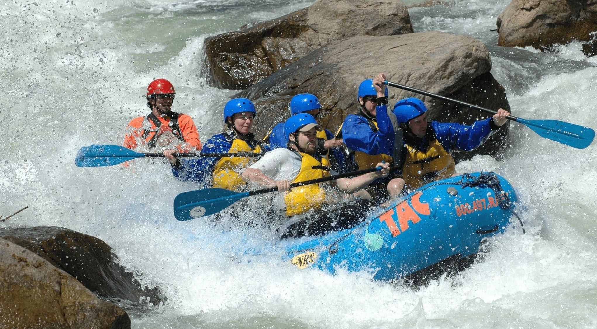 A rafting boat encounters rapids in the Blue River