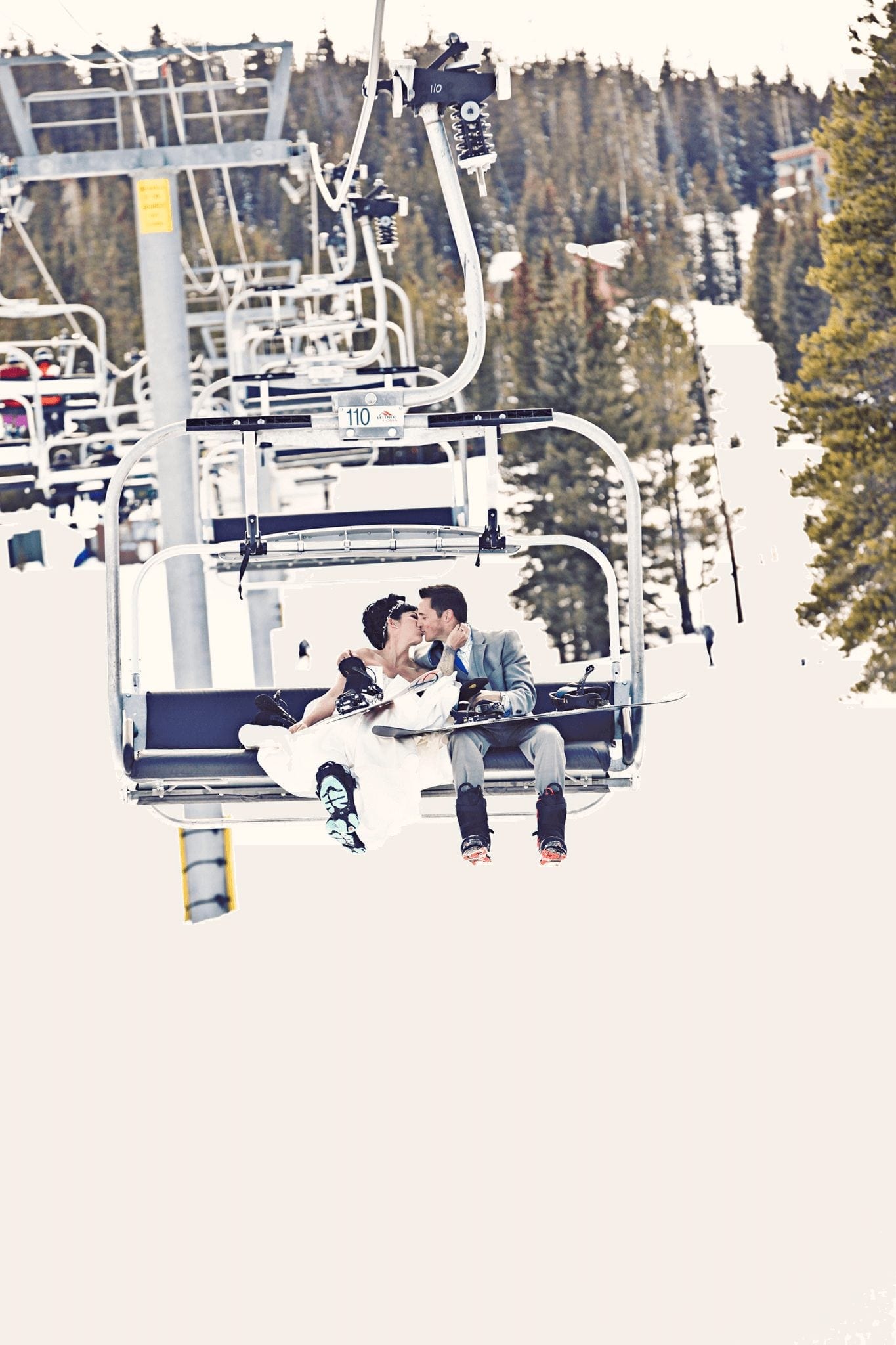 Winter Wedding in Breckenridge: couple sitting on ski lift in the snow