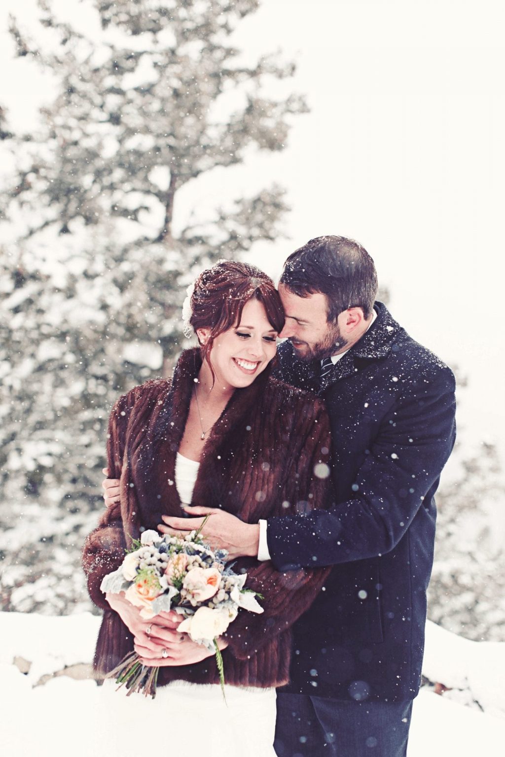 Colorado Winter Wedding Couple Posing While Snowing