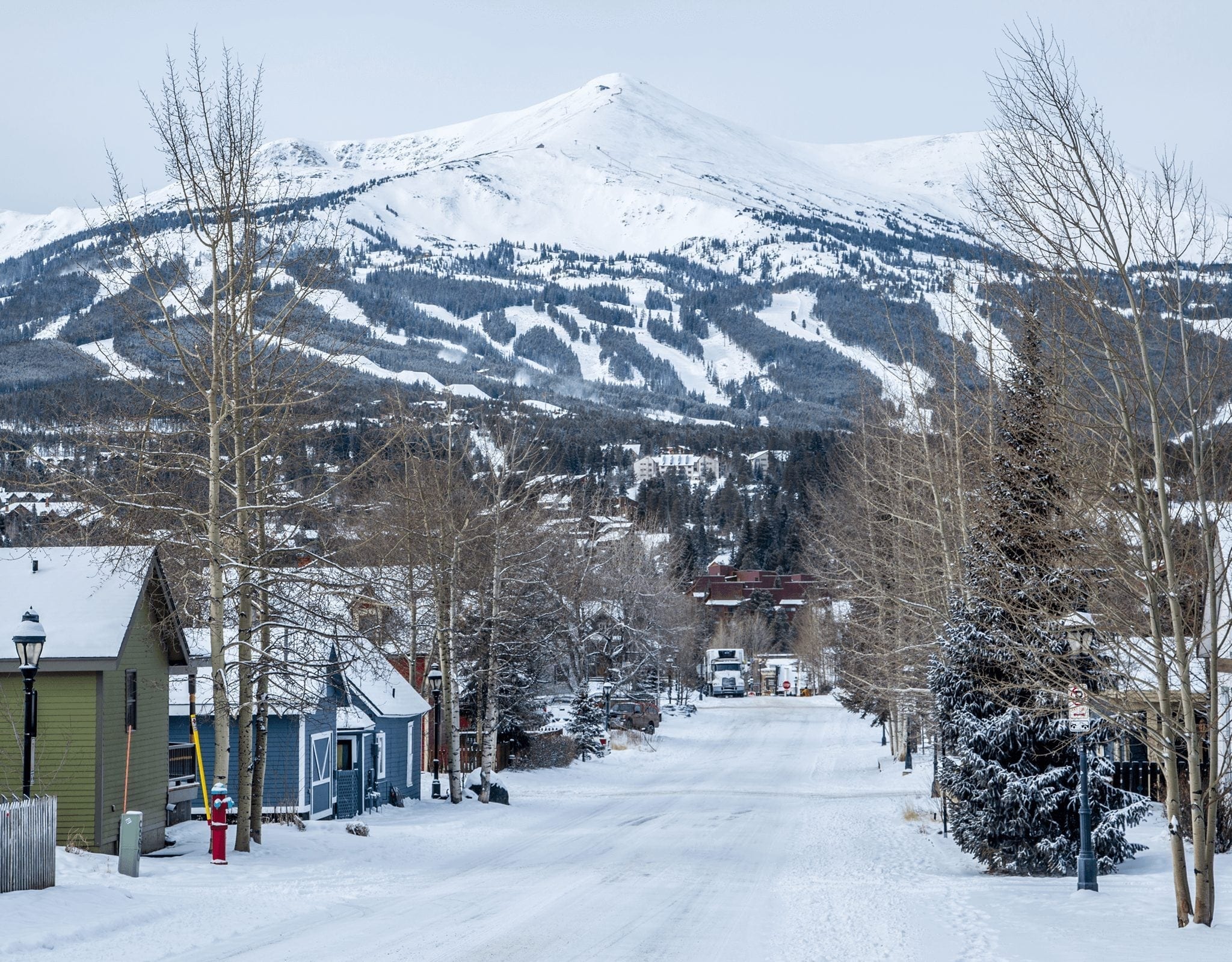 Downtown Breckenridge covered in snow with mountains in the distance. 