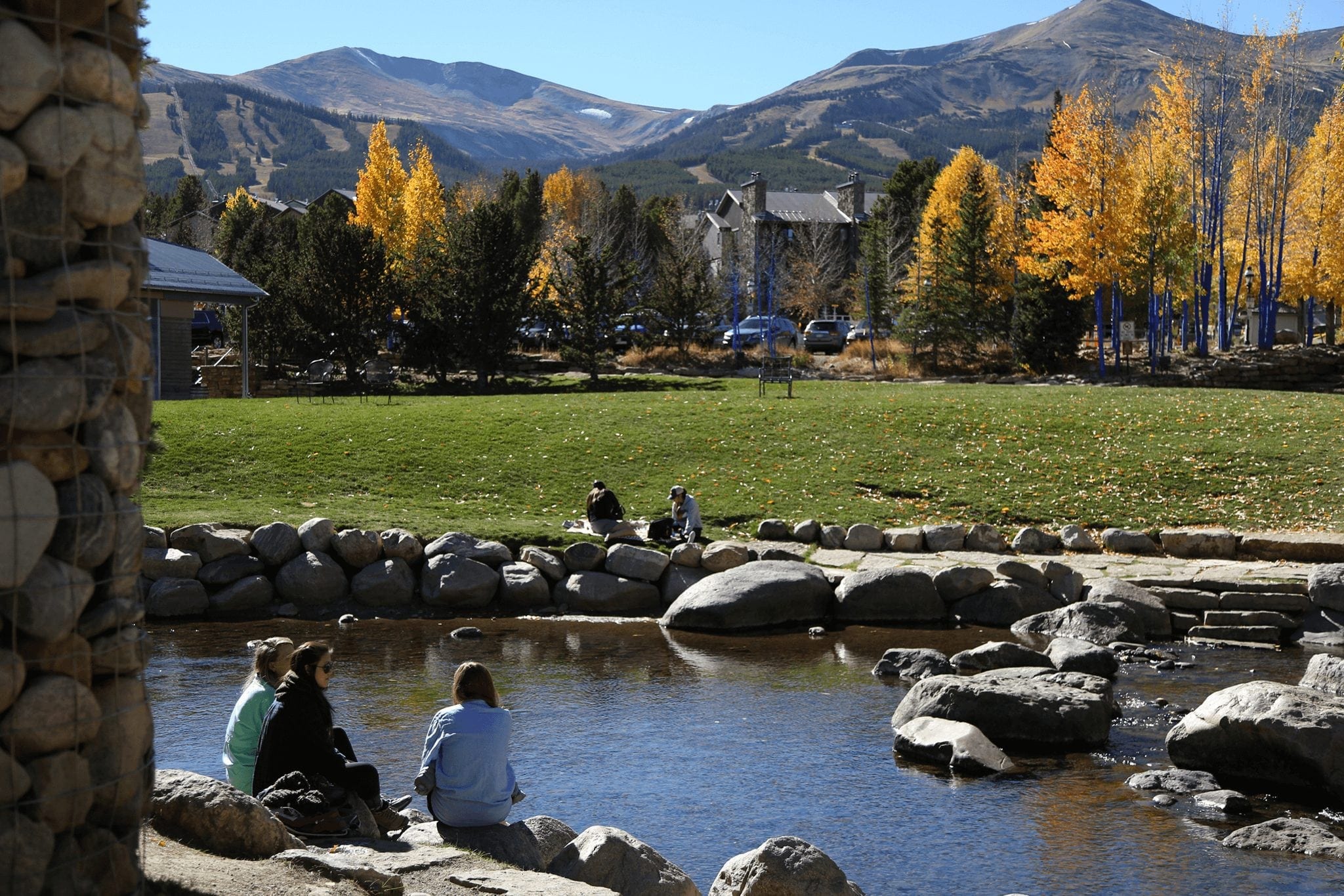 Fall People Sitting by River in Breckenridge