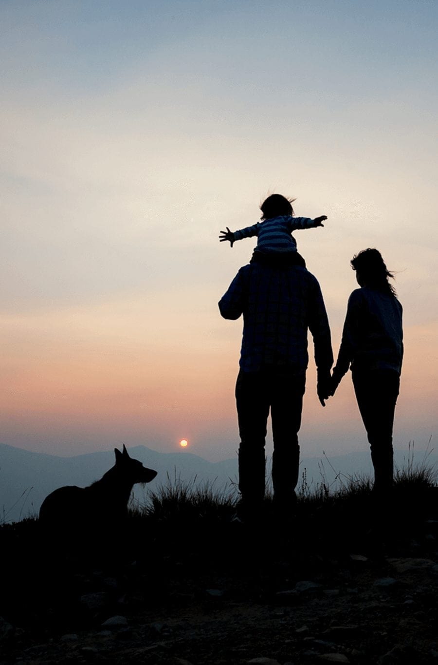 Silhouettes of a family and dog during a sunset hike in Breckenridge