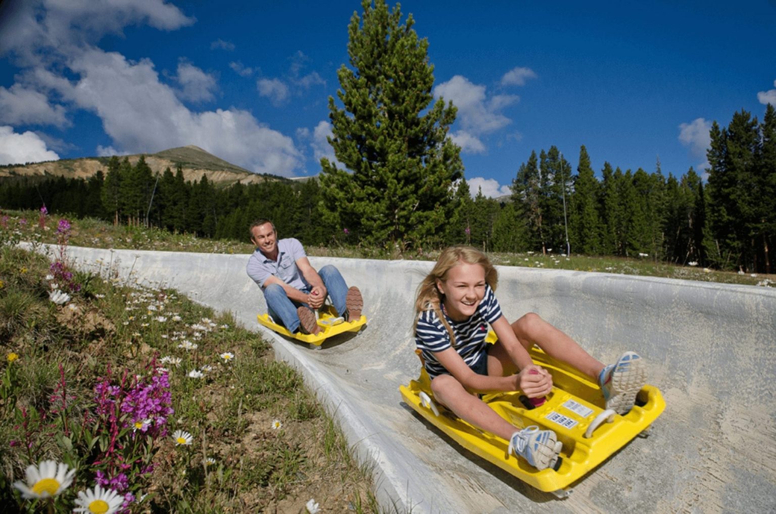 Father and daughter on the Alpine Slide at Breckenridge Ski Resort