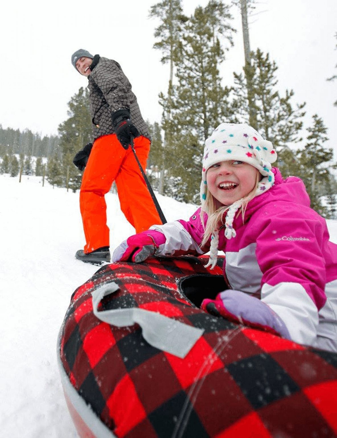 Father pulls daughter uphill in tube sled in Breckenridge