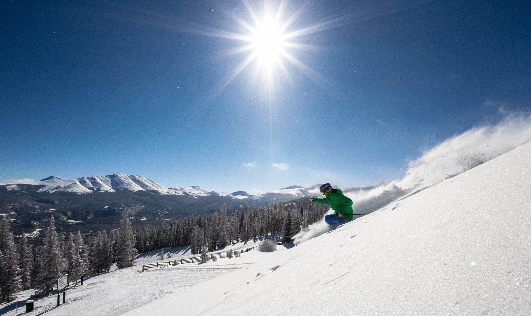 A skier on fresh powder during a beautiful day at the Breckenridge Ski Resort