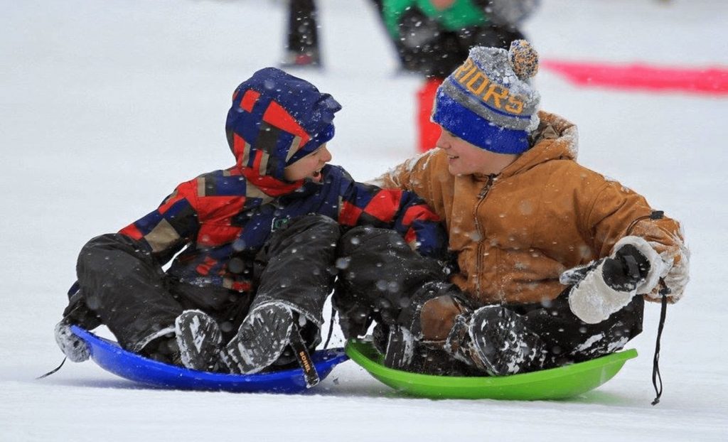 Kids sledding in the snow in Breckenridge