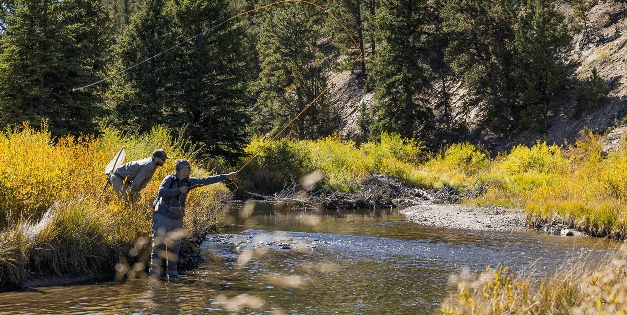 A man casting his line while fly fishing in Breckenridge