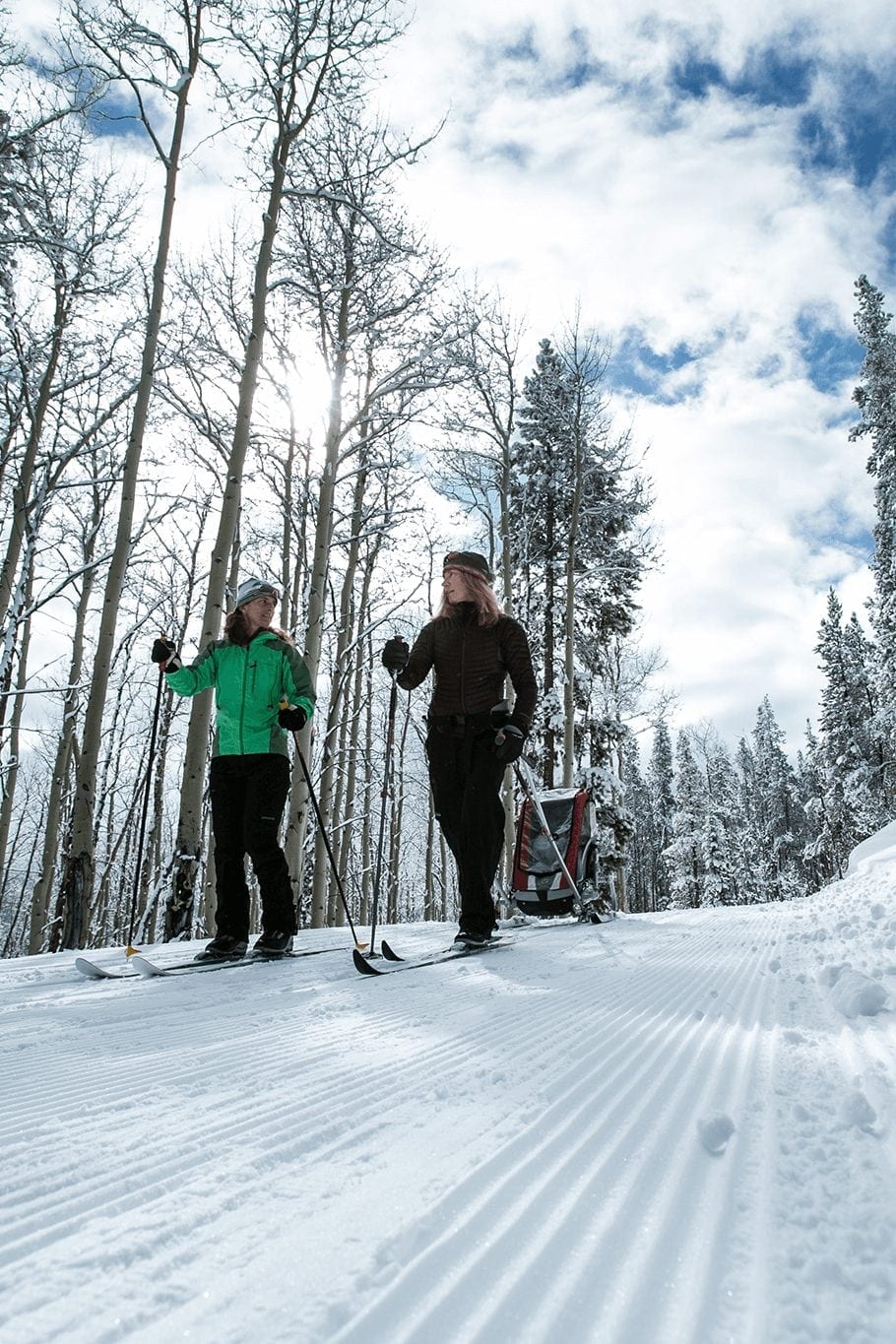 Two women cross country skiing on a sunny day in Breckenridge.