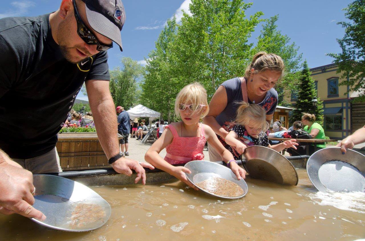 Family panning gold from sluice in Breckenridge