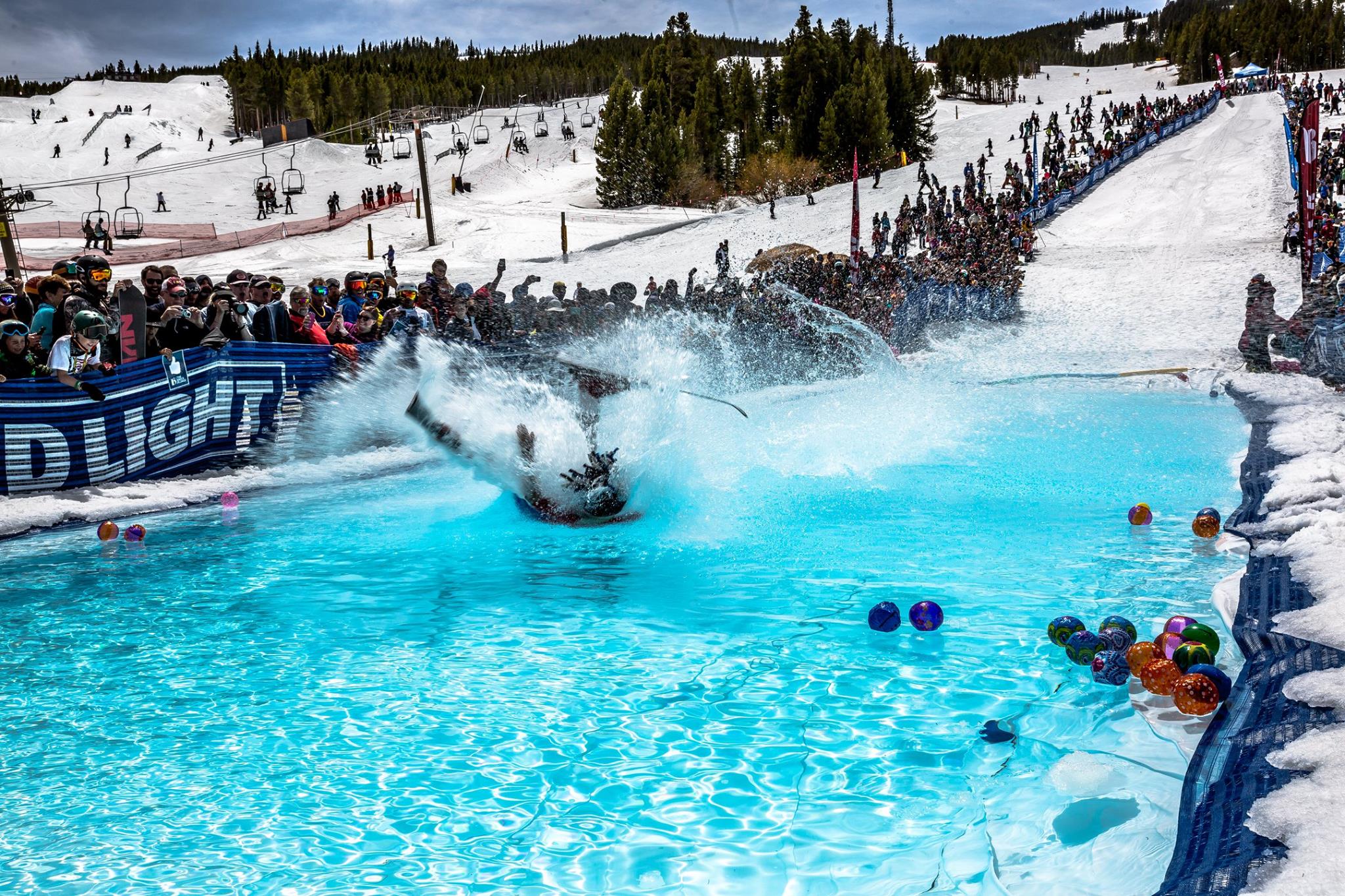 A skiier falling into the water during the Breck Plunge at Breckenridge Ski Resort.