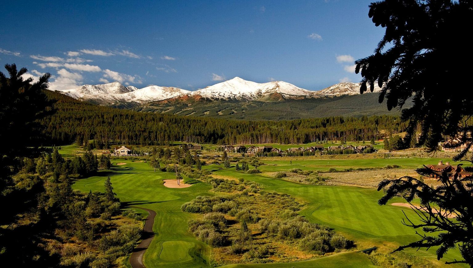 Overview of Breckenridge Jack Nicklaus Golf Club with mountains in background.