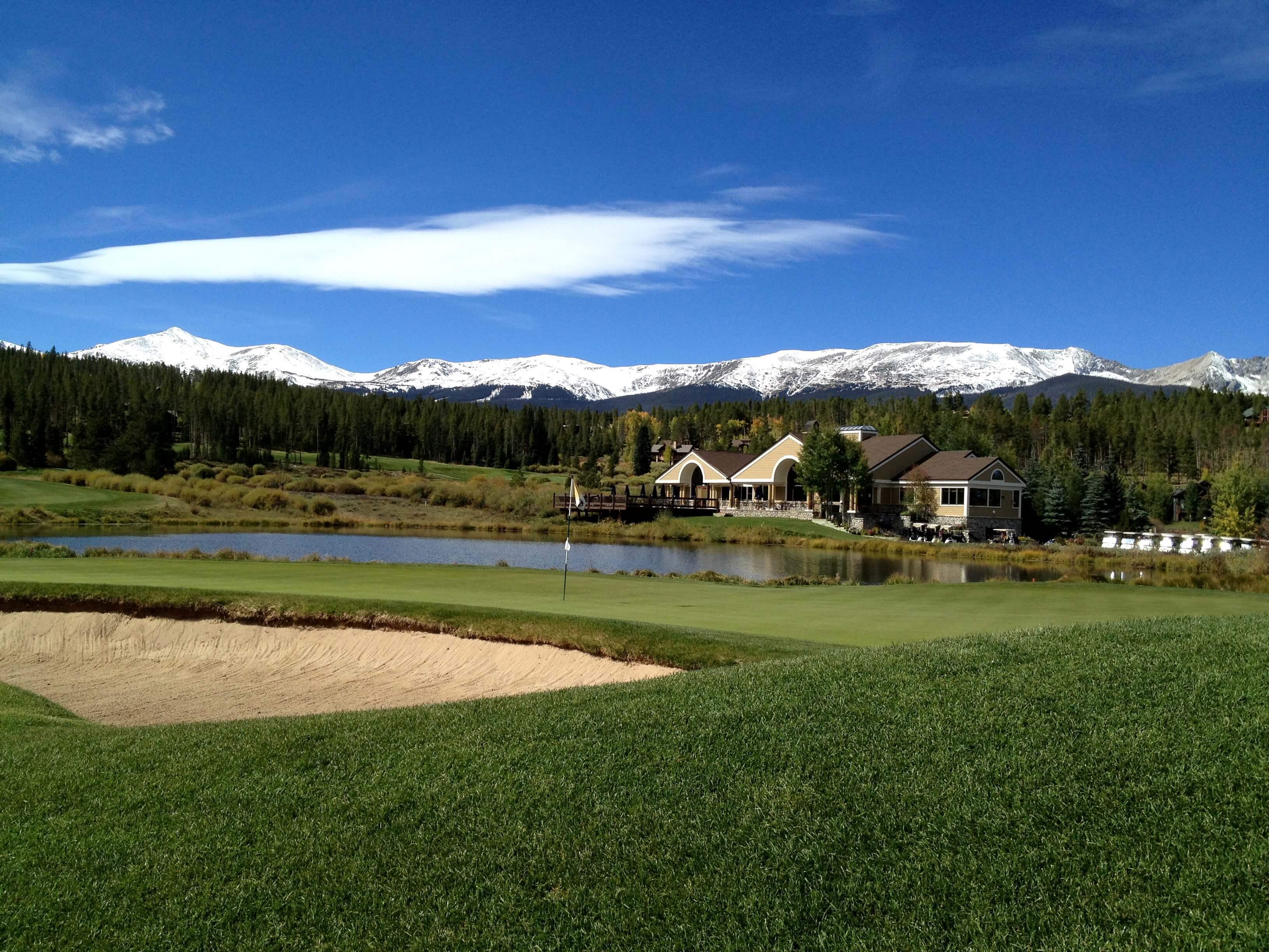 Breckenridge Golf Club's Club House with water hazard and mountain views. 