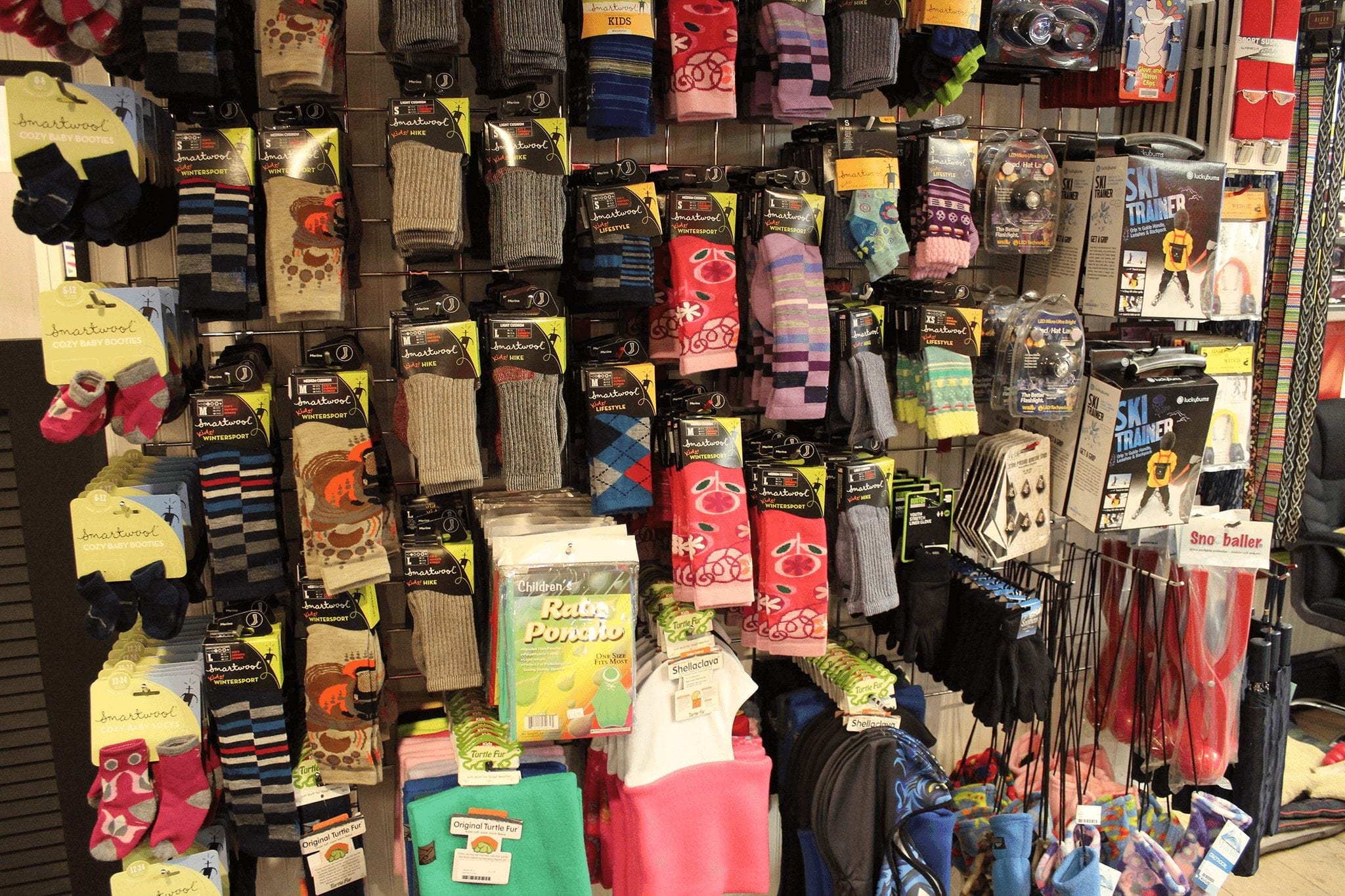 A rack of kid's socks at a winter retail location in downtown Breckenridge. One of the best tips for a trip to Breckenridge is to buy warm socks.