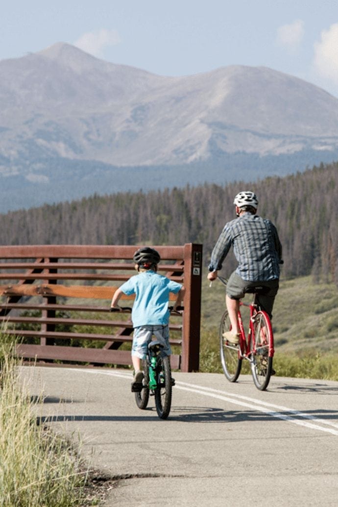 Father and Son Biking on the Blue River Recreational Path in Breckenridge