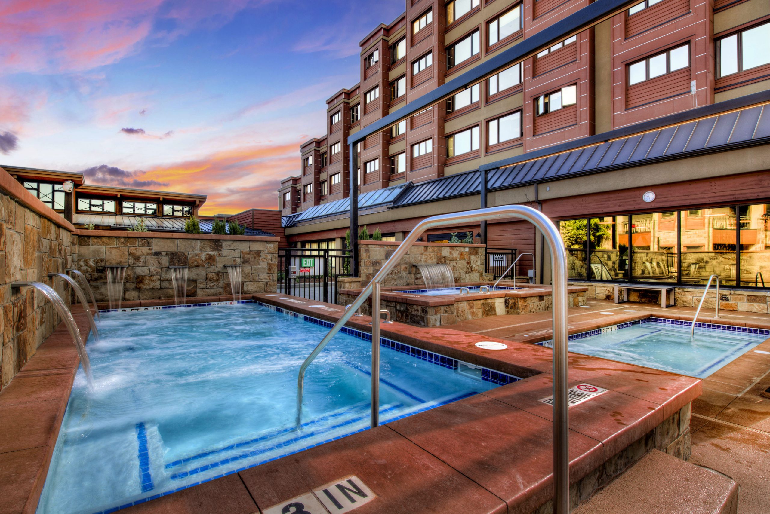 Three outdoor hot tubs outside of Village at Breckenridge