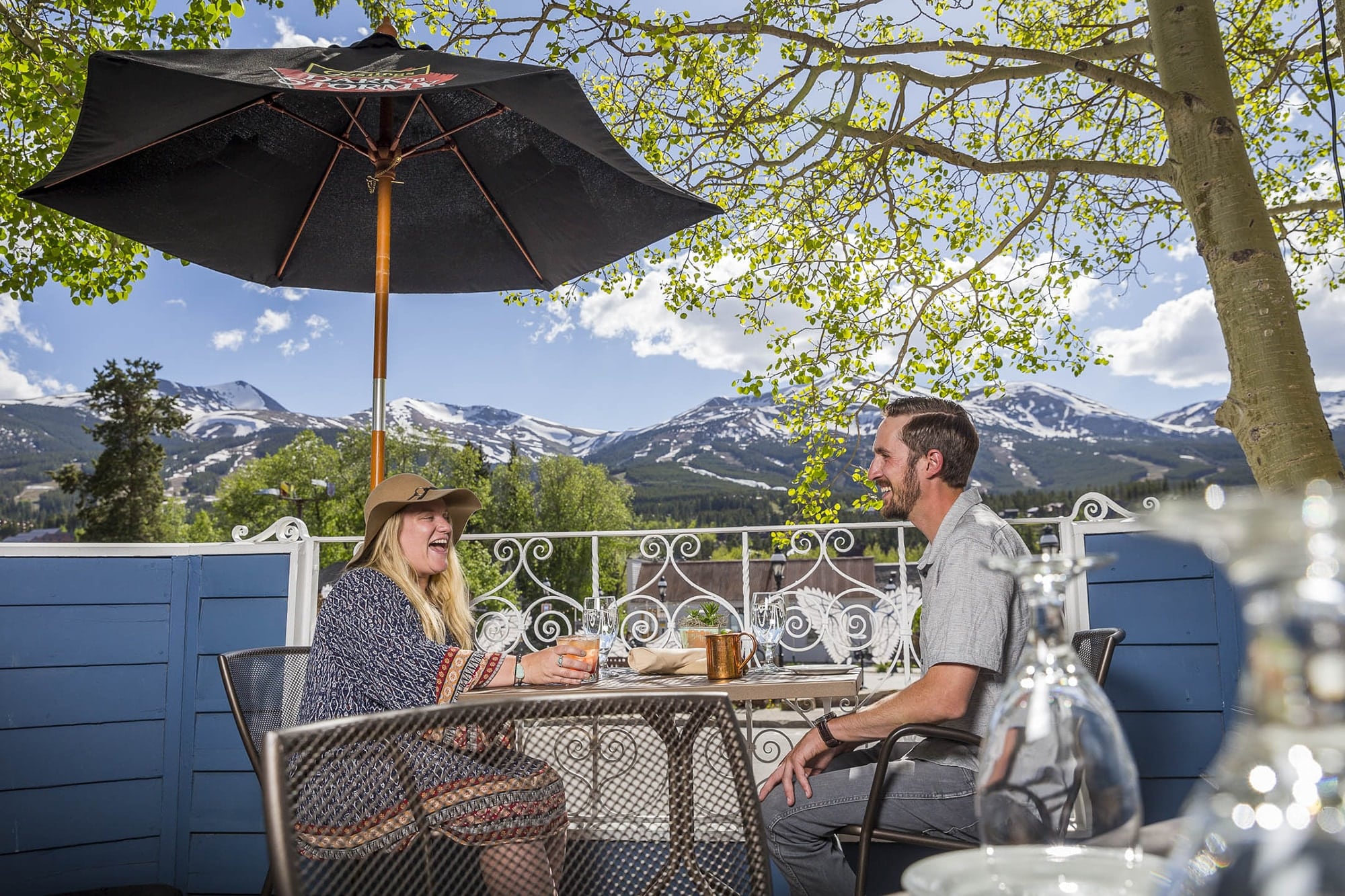 A couple on Hearthstone patio in the summer in Breckenridge 