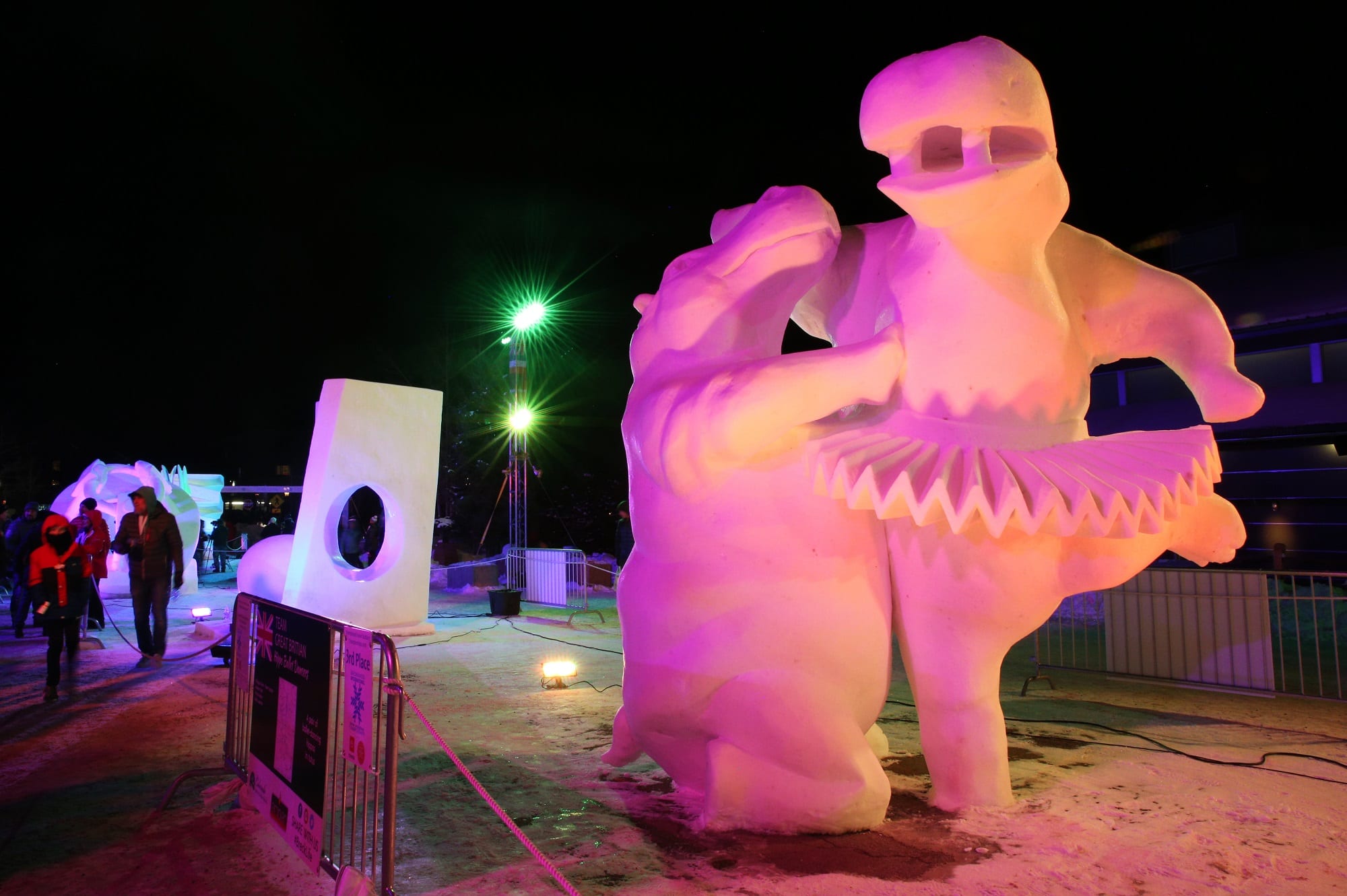 Snow Sculptures lit up by night for viewing.
