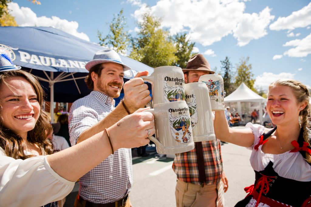 A group at Oktoberfest toasting beer steins