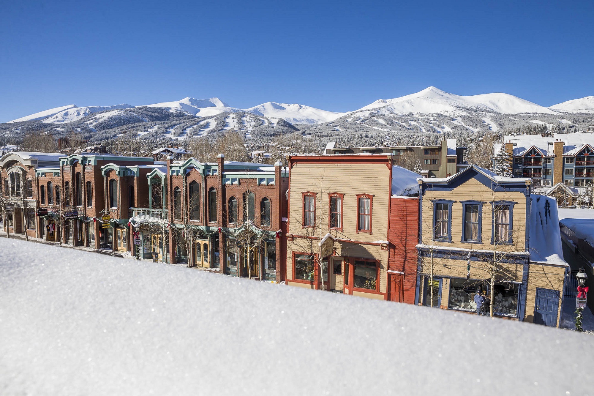 Breckenridge in winter: downtown covered with snow and mountains in the background 