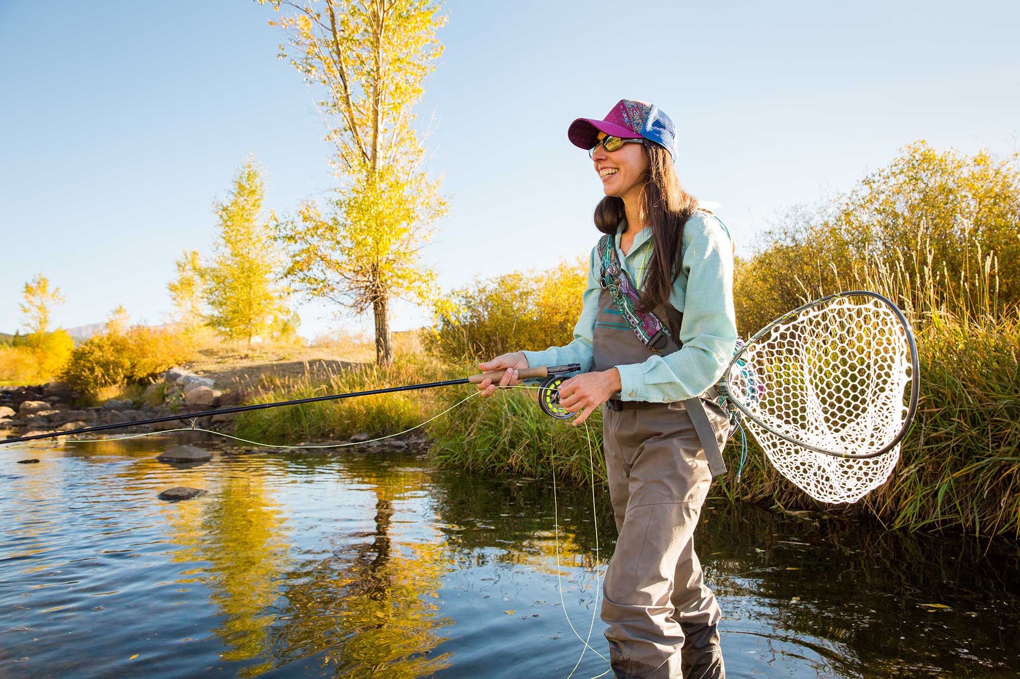 Woman fly-fishing in Breckenridge Blue River 