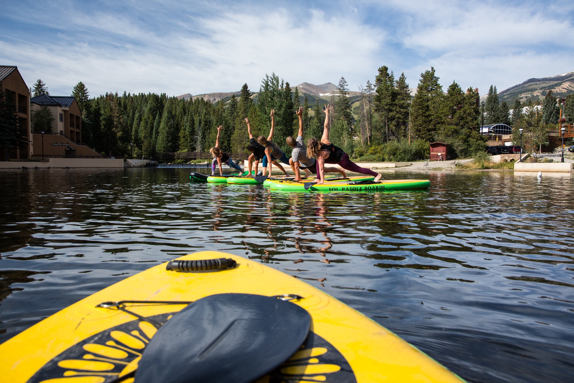 People doing SUP yoga on the Maggie Pond in Breckenridge.