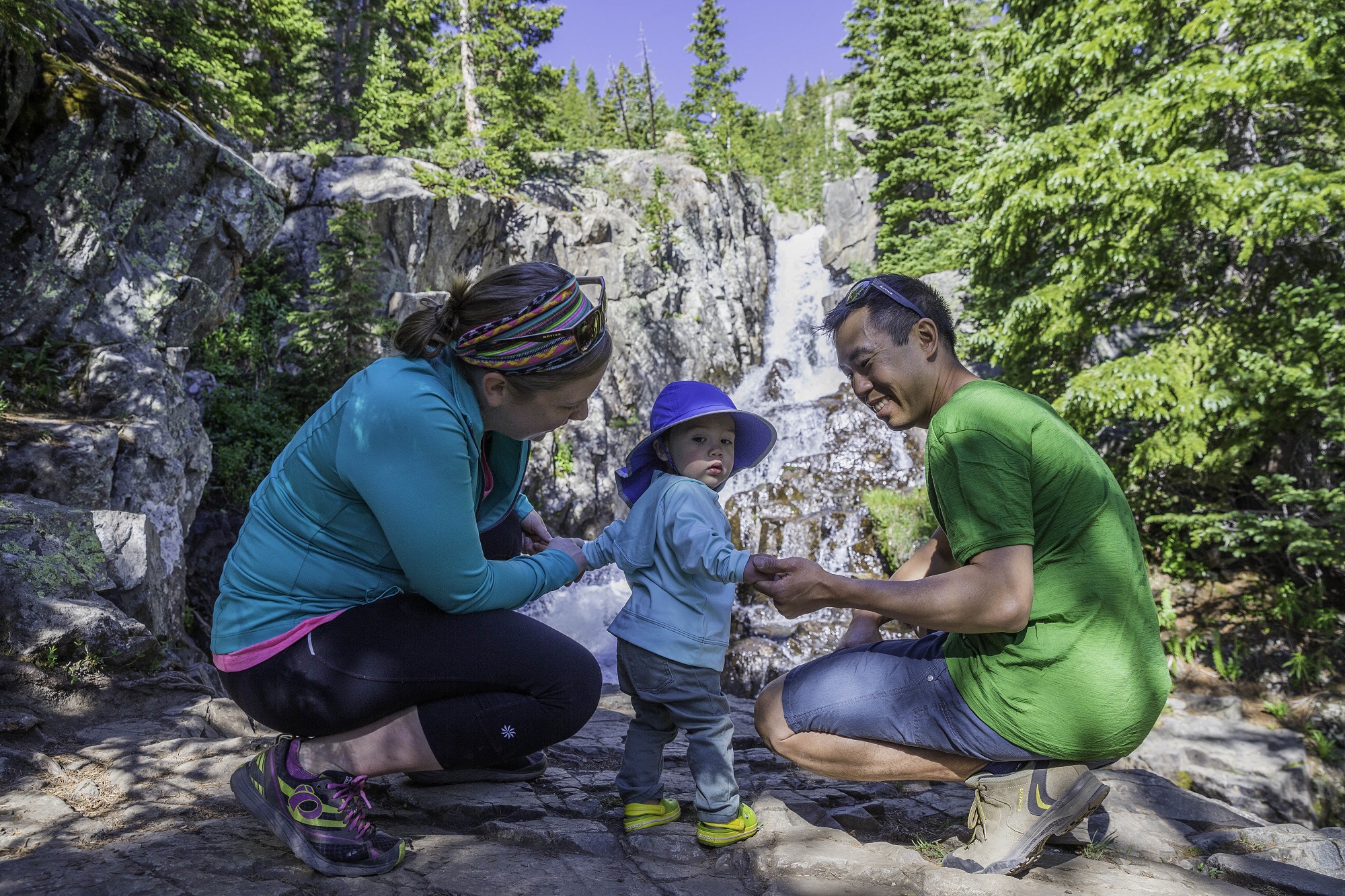 Family hiking and seeing a waterfall at Mohawk lakes in Breckenridge