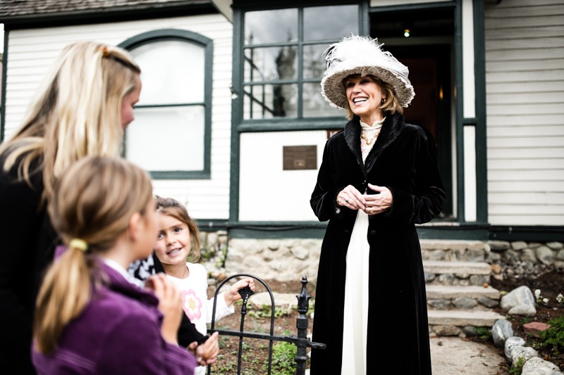 A woman in costume giving a Breckenridge ghost tour