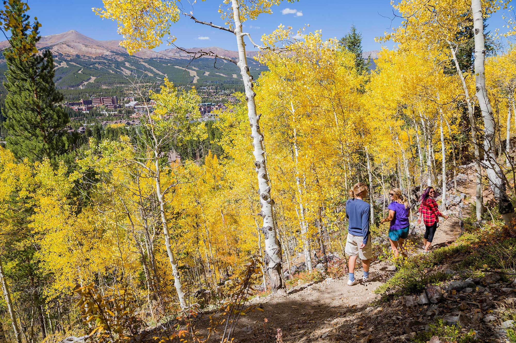 Friends on a fall hike with aspen and mountain views in Breckenridge, CO