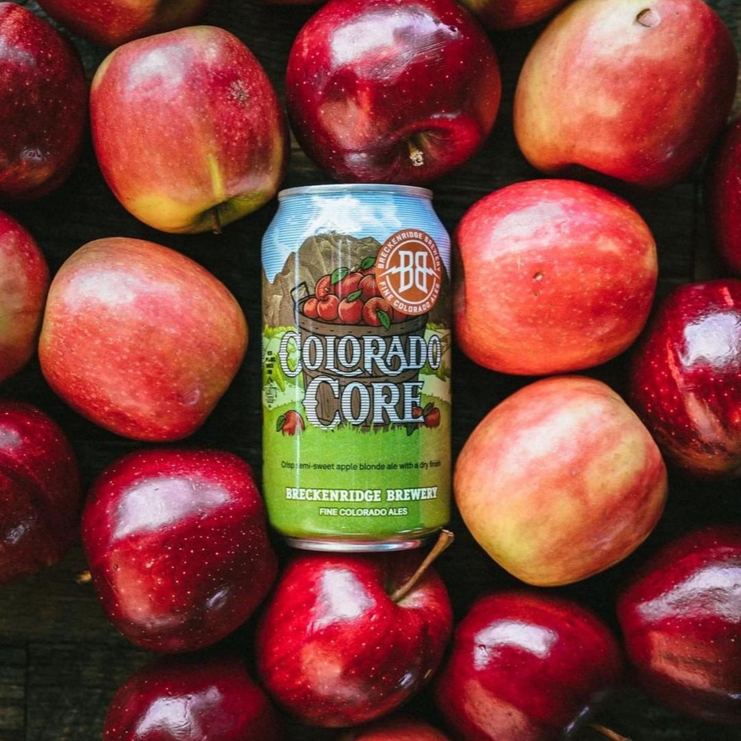 Apple flavored beer can surrounded by apples