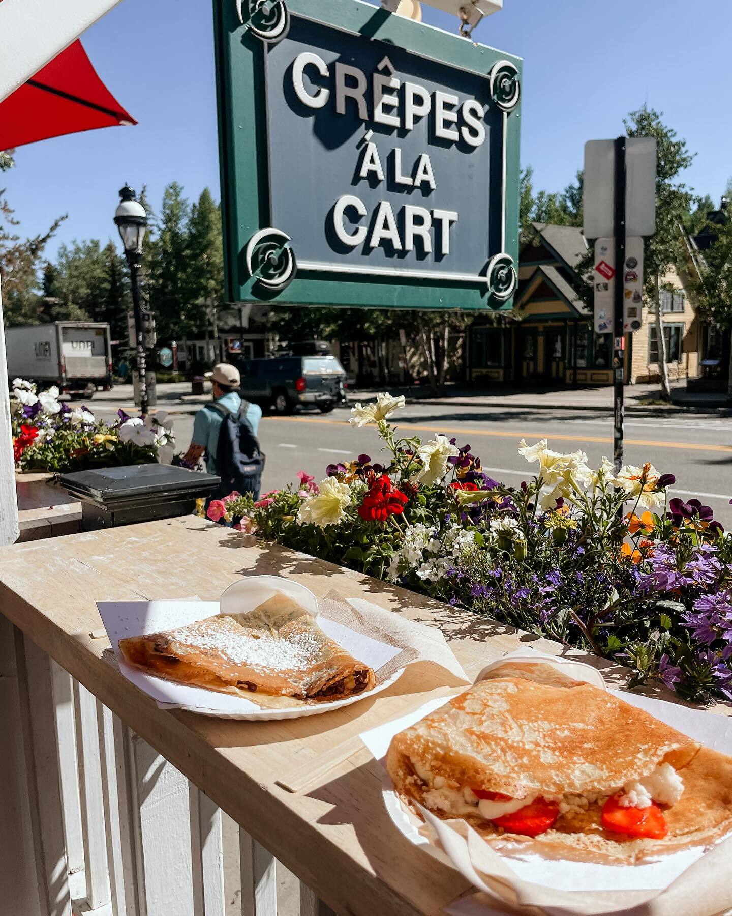 Two dessert crepes being enjoyed outside on a beautiful summer day on Main Street in Breckenridge.