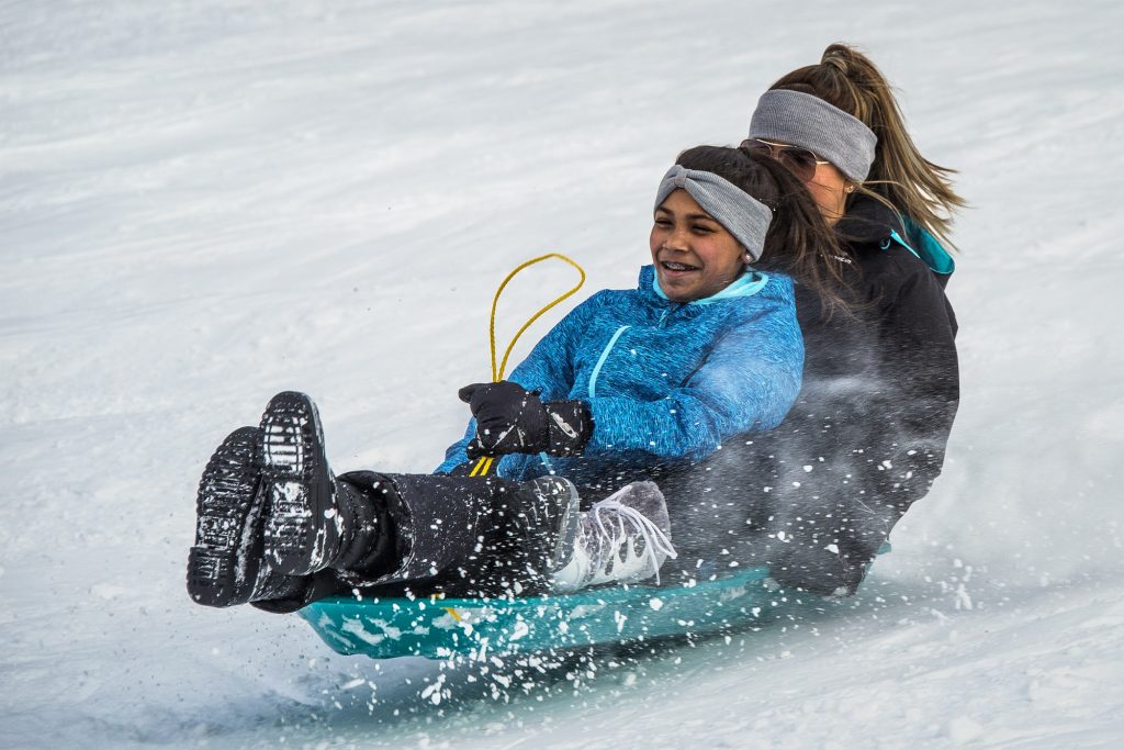 Mom and daughter sledding in Scofield in Breckenridge