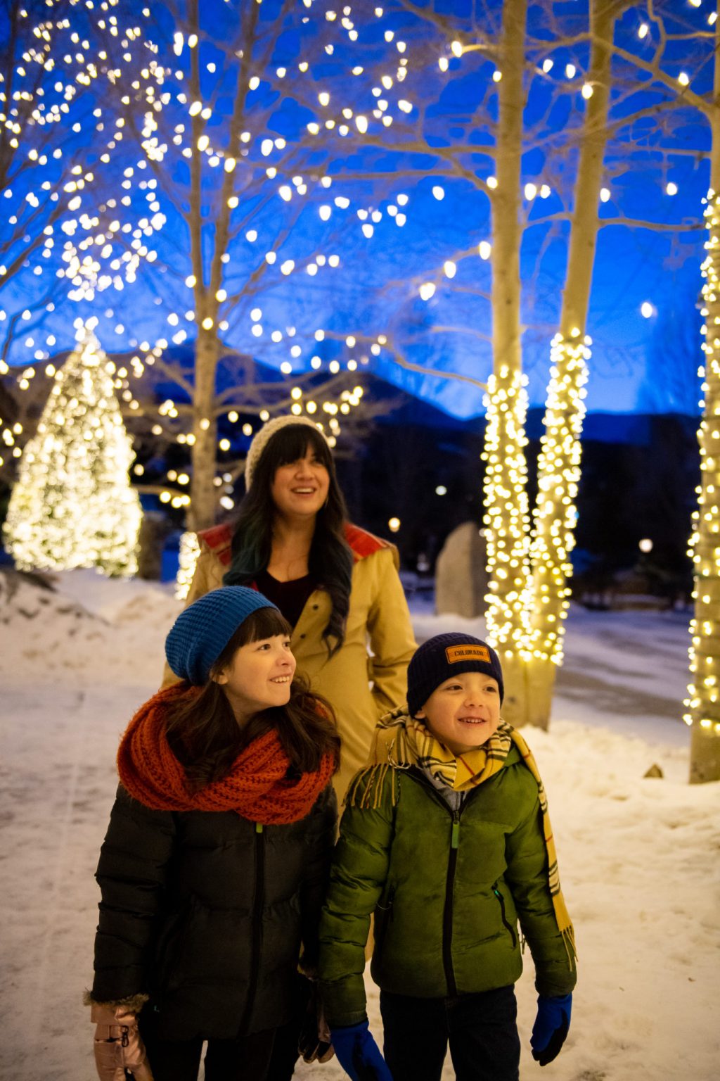 family admiring Christmas lights