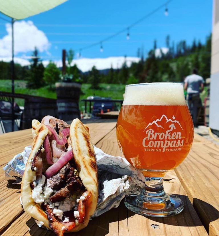 beer and a gyro on a picnic table