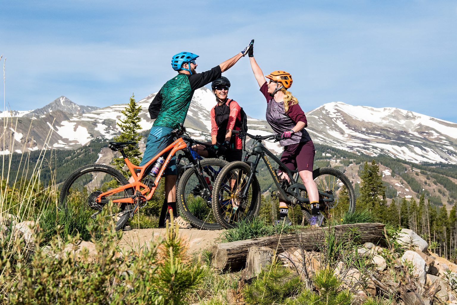 Mountain bikers in Breck giving high fives