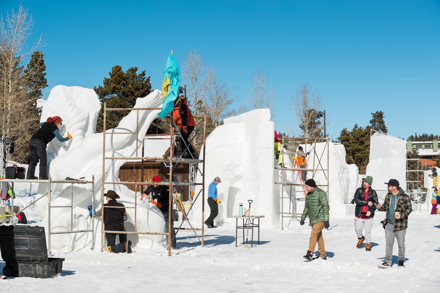 groups of people working on snow sculptures