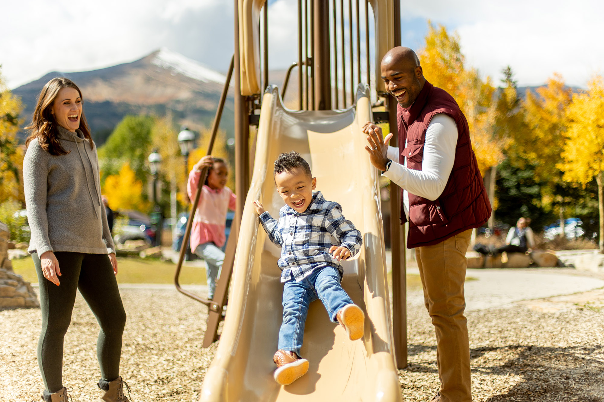 family plays at park in Breckenridge during fall