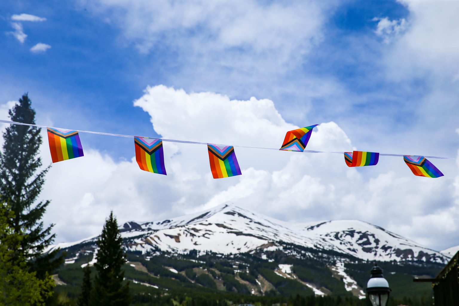 A string of pride flags is photographed infront of Breckenridge Ski Resort.