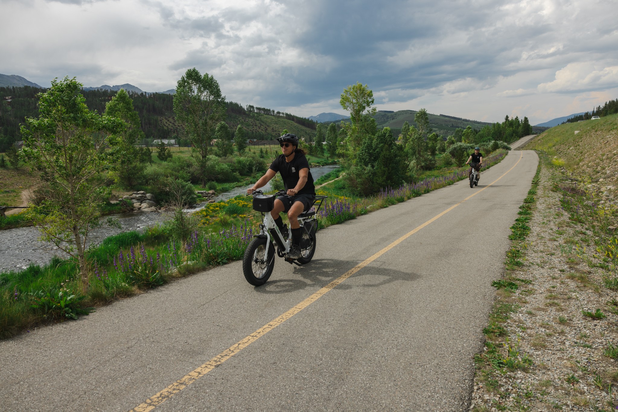 Two people using ebikes along the Rec Path in Breckenridge, Colorado.